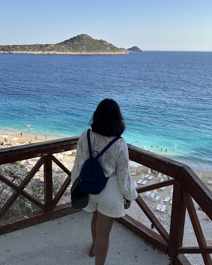 Anju looking out over a turquoise bay on the Turkish Riviera