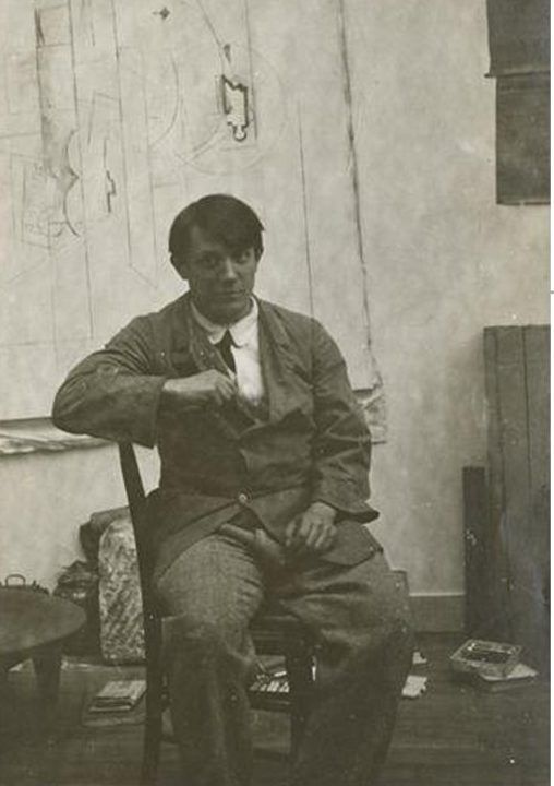 Young Picasso seated in his studio