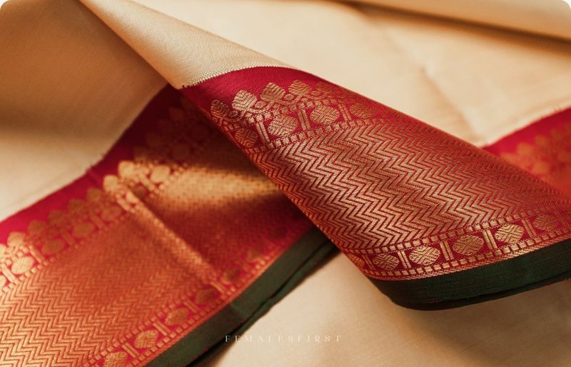 A red Banarasi border with gold zari folded over cream silk